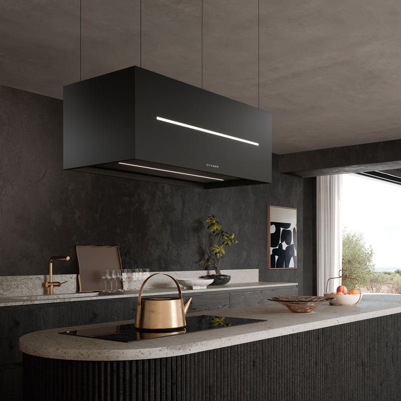 A modern kitchen with a sleek, minimalist design. The focal point is a large, rectangular Faber Graziosa black range hood suspended from the ceiling above an island countertop.
