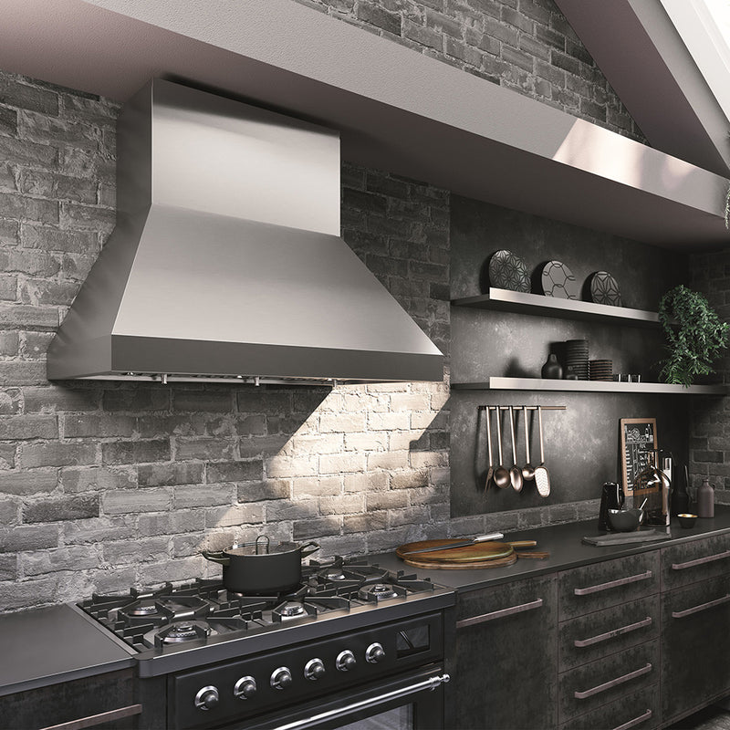 Stainless steel Faber Camino pro wall kitchen range hood in a modern kitchen setting lifestyle image. brick backsplash gray, industrial cabinets.