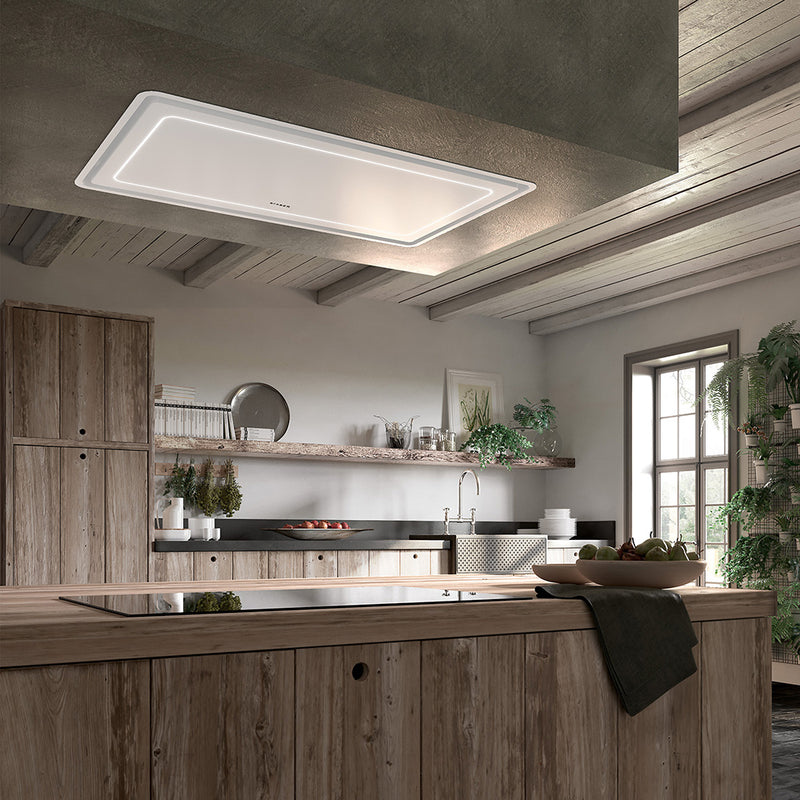 faber high-light white matte with stainless rim island & ceiling kitchen range hood with perimeter aspiration lifestyle image in a rustic kitchen setting