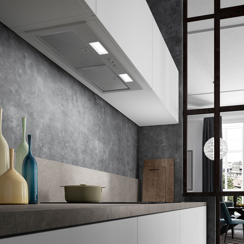 Faber Inca Smart Range Hood in a Modern kitchen with concrete wall, countertop, and decorative items.