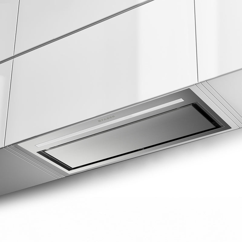 faber inca lux plus lifestyle stainless steel insert kitchen range hood with hidden controls, led light bar, and perimeter aspiration close up in white cabinets