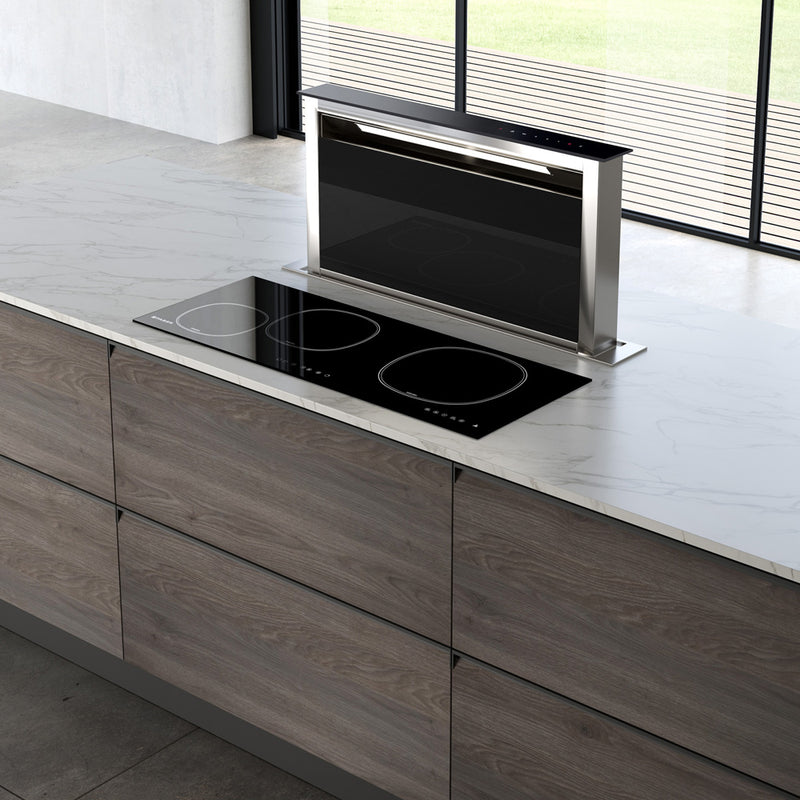 Faber Scirocco Lux down draft hood paired with a stove top in a bright kitchen