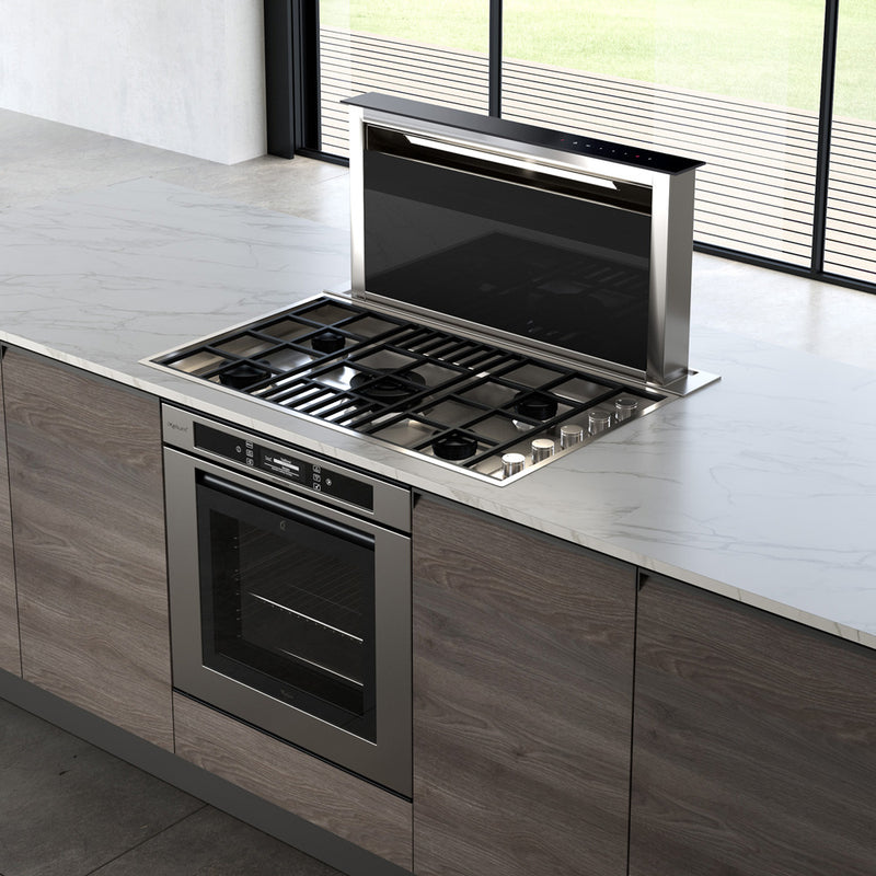 Faber Scirocco Lux down draft hood paired with a gas stove in a bright kitchen