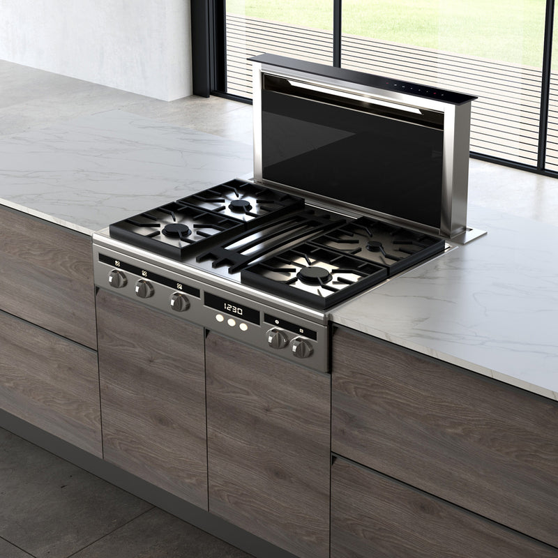 Faber Scirocco Lux down draft hood paired with a gas stove top in a bright kitchen