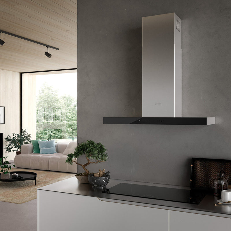 Faber Stilo Suprema wall range hood on a grey wall over a stove top in a modern kitchen