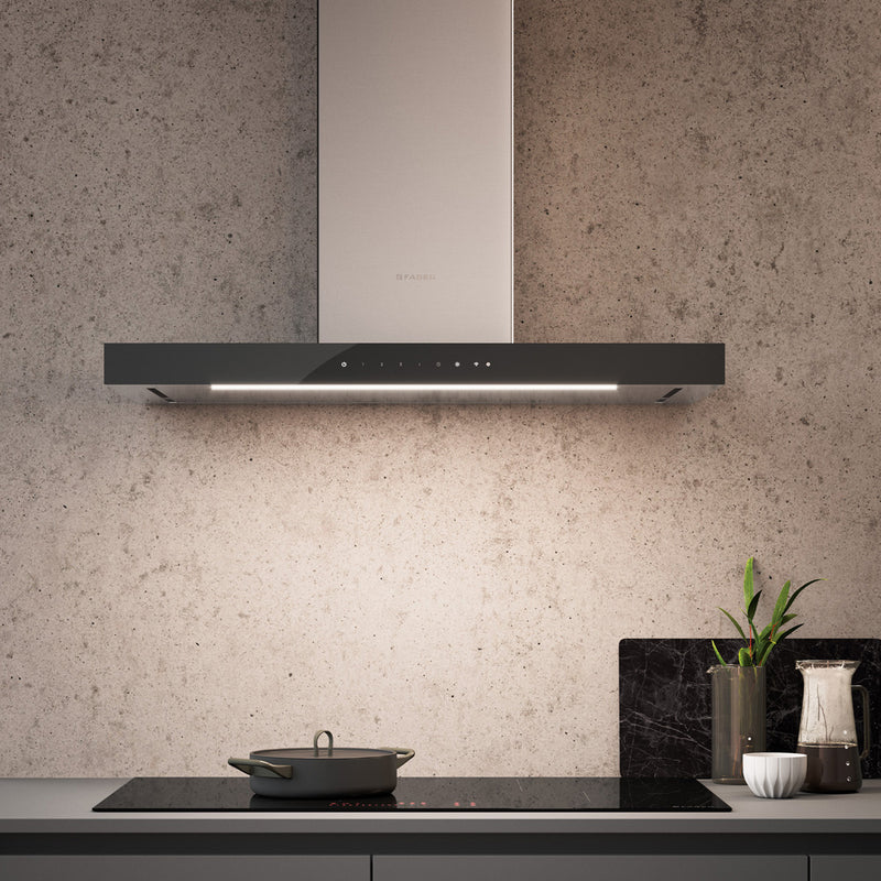 Faber Stilo Suprema kitchen range hood illuminating a modern stove top in a contemporary kitchen.