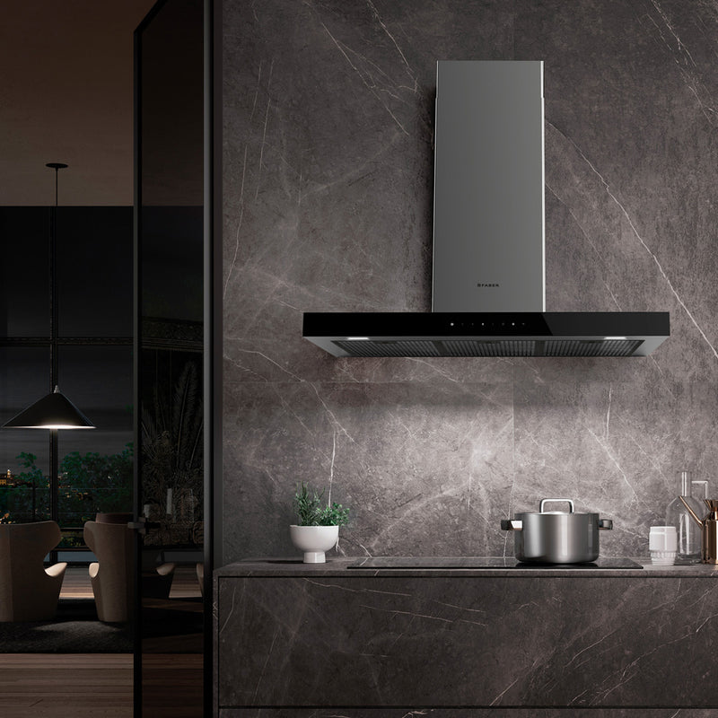 Dark moody modern kitchen with a grey marble black splash featuring a sleek stove top and beautiful Faber Stilo Glass kitchen range hood
