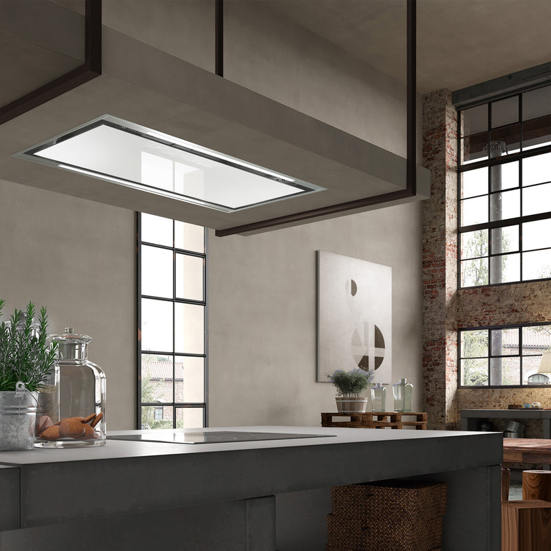 Modern industrial kitchen featuring an island with stove top and a Faber Stratus Isola White Glass with stainless steel rim range hood overtop top.